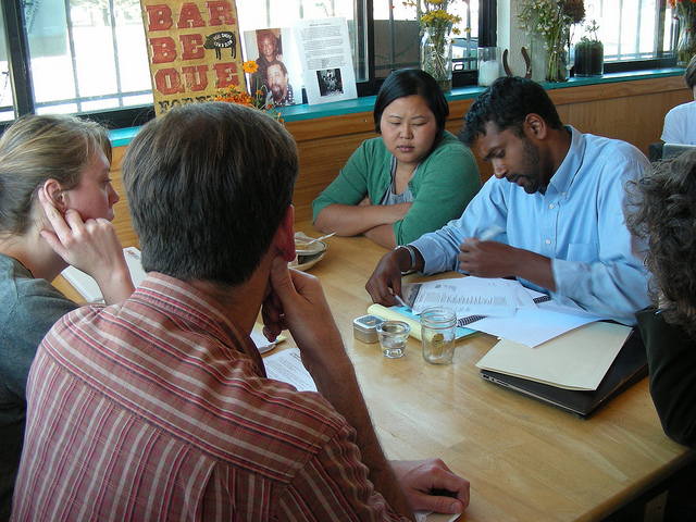 Attorney Sushil Jacob and apprentice Thea Chhun advice clients at the Legal Cafe